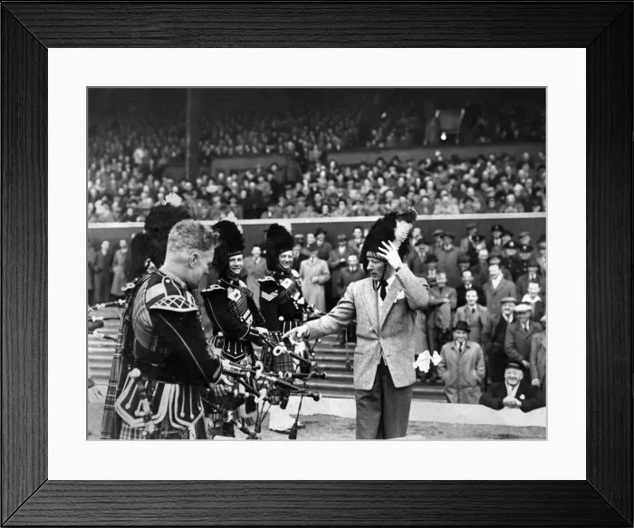 Framed Print : American actor and comedian Danny Kaye, complete with busby puts the Pipe band through