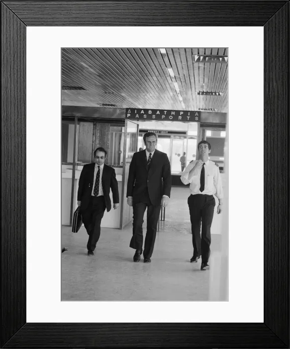 Framed Print : Leeds United manager Don Revie goes through passport control in Greece as the team return
