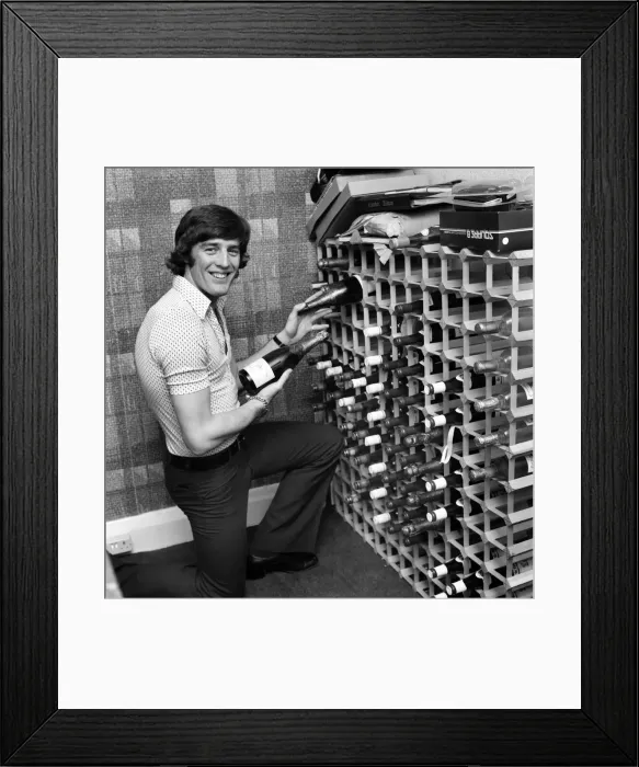 Framed Print : Chelsea striker Ian Hutchinson selects a suitable bottle of champagne in readiness for