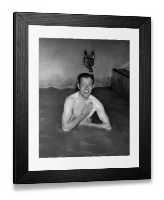 Framed Print : Manager Bert Flatley, ex-Buckley-boy, enjoys a bath after playing with the team in their