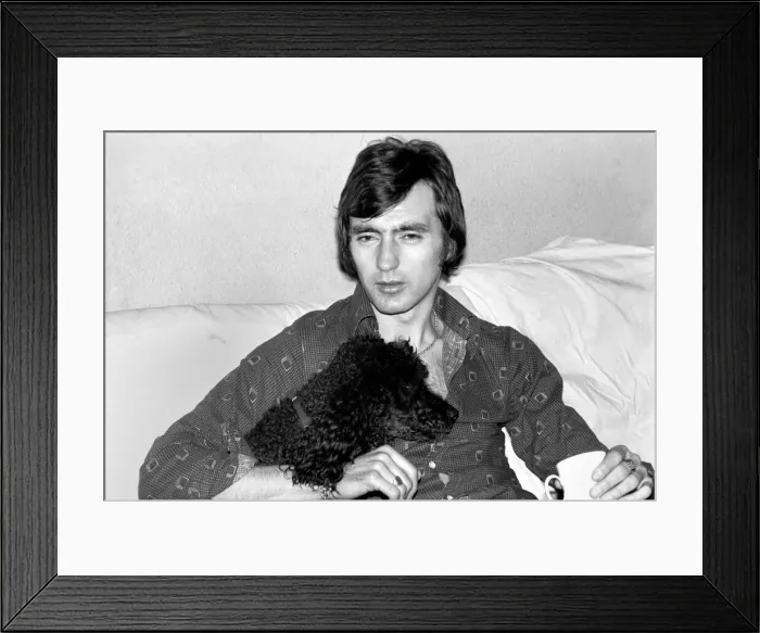 Framed Print : England and Stoke international hero Alan Hudson seen here with his pet poodle Framed Print : England and Stoke international hero Alan Hudson seen here with his pet poodle