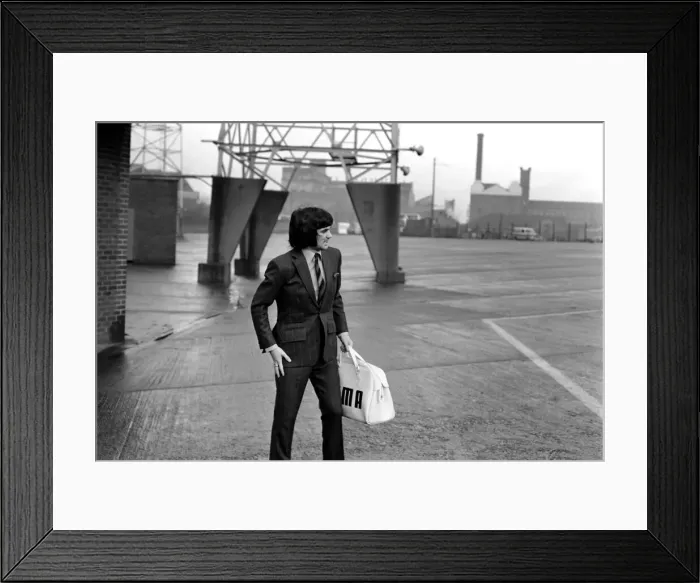 Framed Print : George Best right as he left Old Trafford ground to board the coach on route to Ipswich