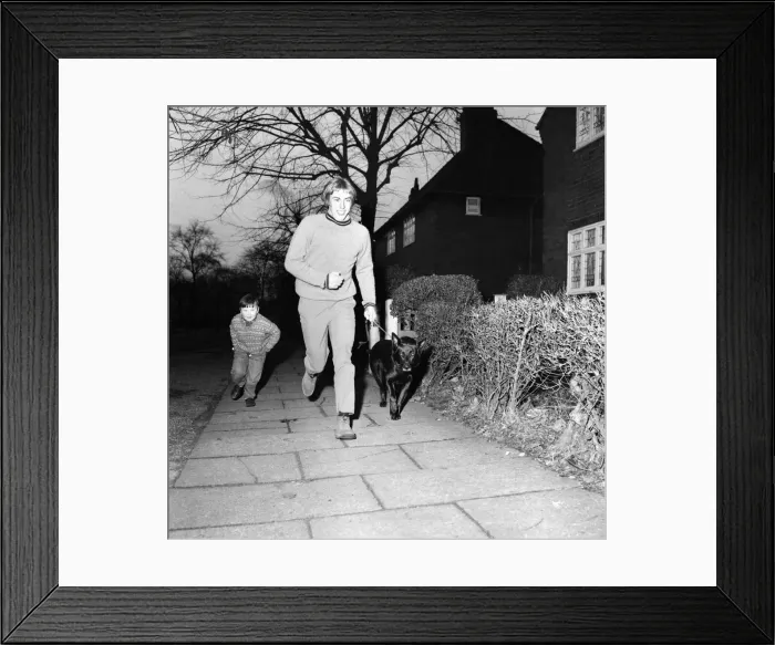 Framed Print : Derek Jeffries takes his dog Blackie for a run in a park near his home in Longsight Framed Print : Derek Jeffries takes his dog Blackie for a run in a park near his home in Longsight