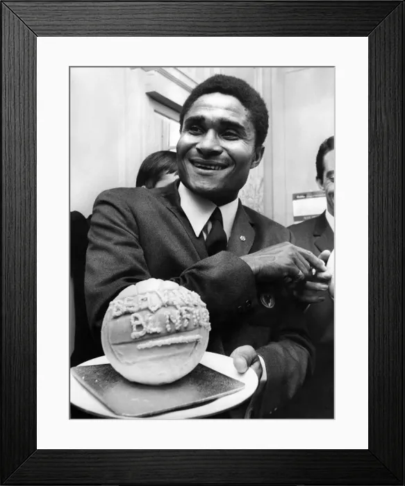 Framed Print : Holding a football made of ice-cream is Eusebio, at a London reception. May 1968 P009852