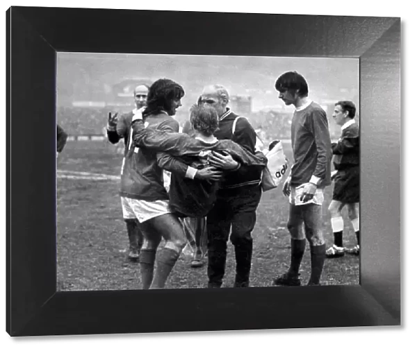 Denis Law of Manchester United being carried off the pitch after an injury