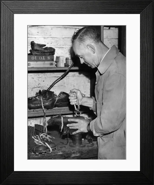 Framed Print : Laurie Barnett is seen attending to Ivor Broadis football boots