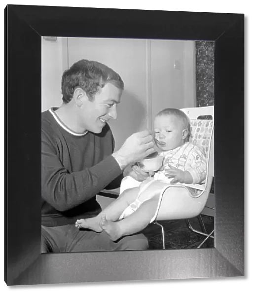 Burnley football player Ralph Coates feeds his new baby girl Lisa. December 1969 Z12543