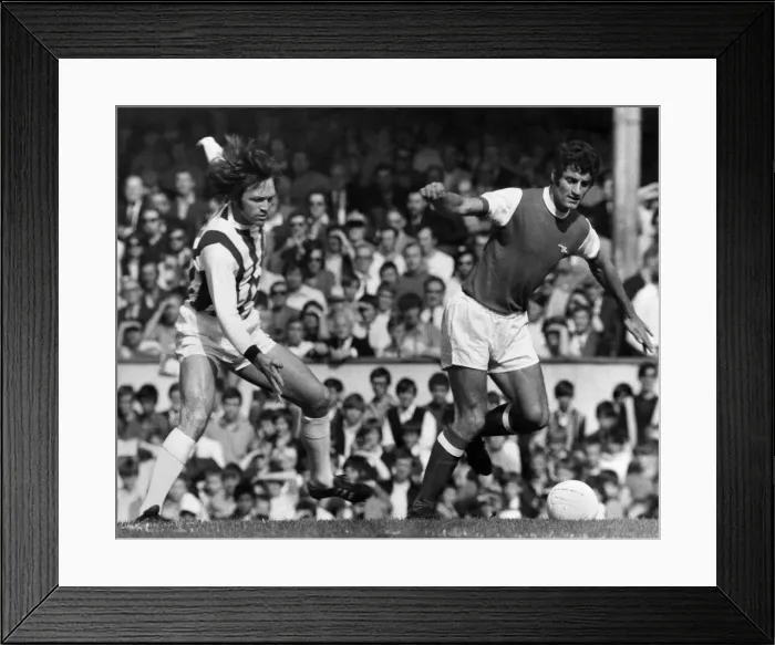 Framed Print : Arsenal v West Bromwich Albion Frank McLintock of Arsenal leaves Jeff Astle