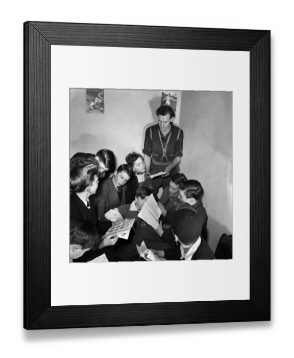 Framed Print : A football coach who runs a junior football club at Windsor with his group of players