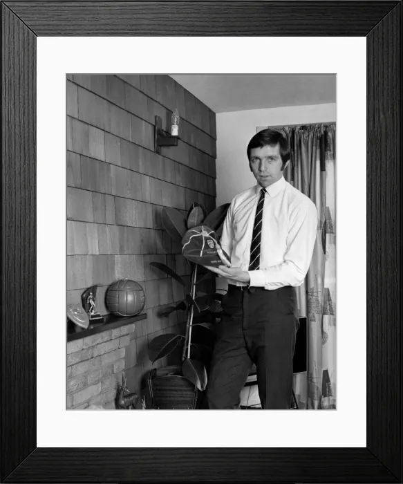 Framed Print : Jeff Astle pictured at home, with some of his trophies and one of his England caps Framed Print : Jeff Astle pictured at home, with some of his trophies and one of his England caps