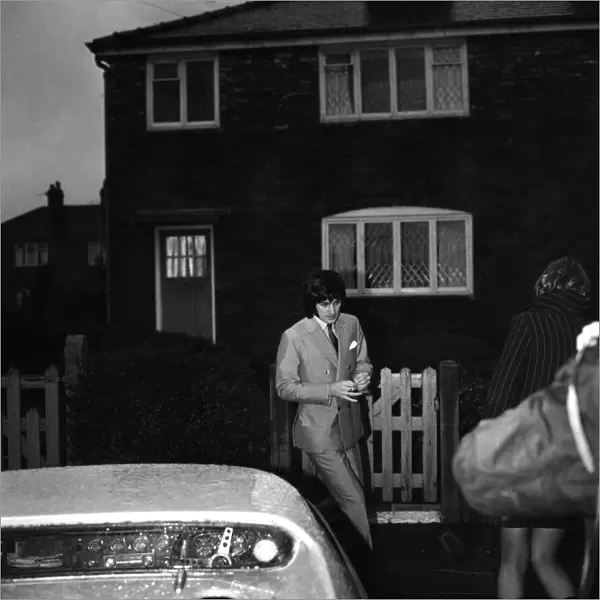Manchester United star George Best leaving the house to go to the match against