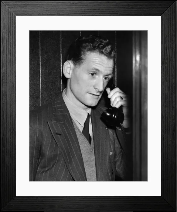 Framed Print : Tom Finney, who plays on the right wing, seems worried as he makes a midnight phone call Framed Print : Tom Finney, who plays on the right wing, seems worried as he makes a midnight phone call