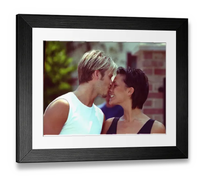 Framed Print : David Beckham and Victoria Adams Posh Spice kissing 1999 outside their home two days