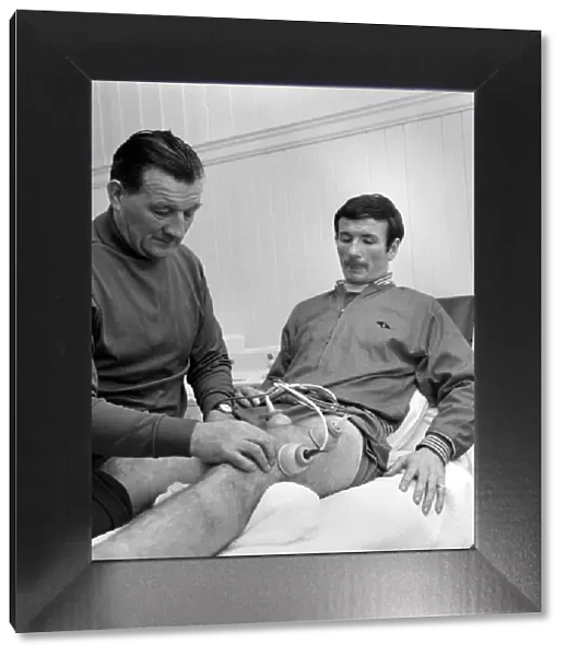Injured Liverpool player Tommy Smith receives treatment from Bob Paisley in the treatment
