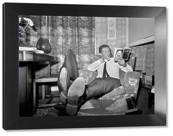Alan Ball the manager of Halifax relaxed at home last night reading a book on famous