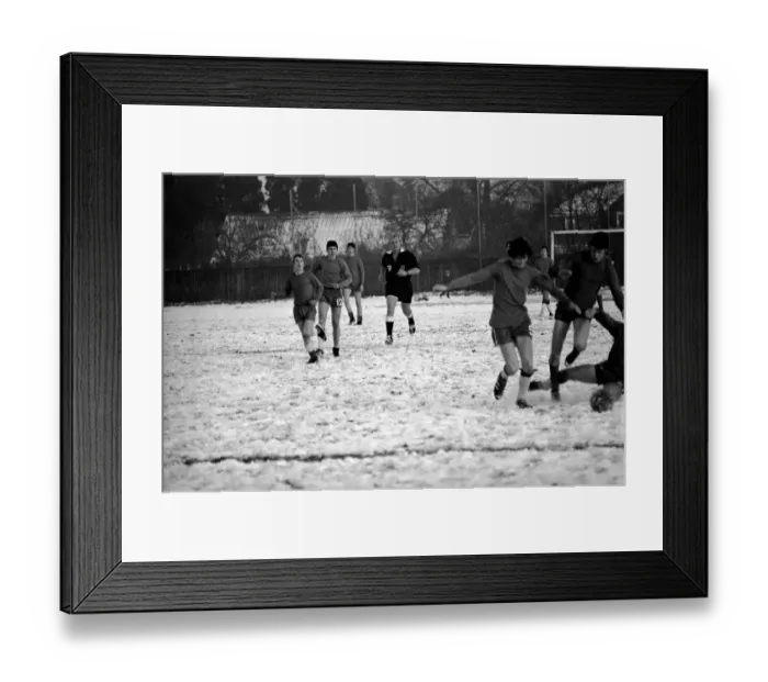 Framed Print : Sport Amateur football youth game in action in the snow near Maidshow between two local