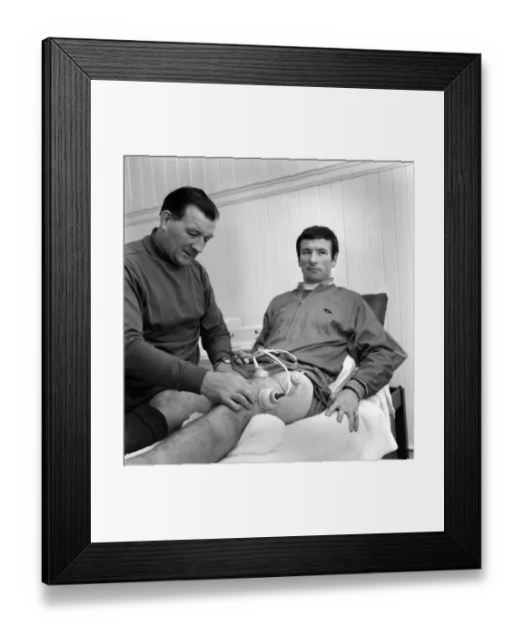 Framed Print : Injured Liverpool player Tommy Smith receives treatment from Bob Paisley in the treatment