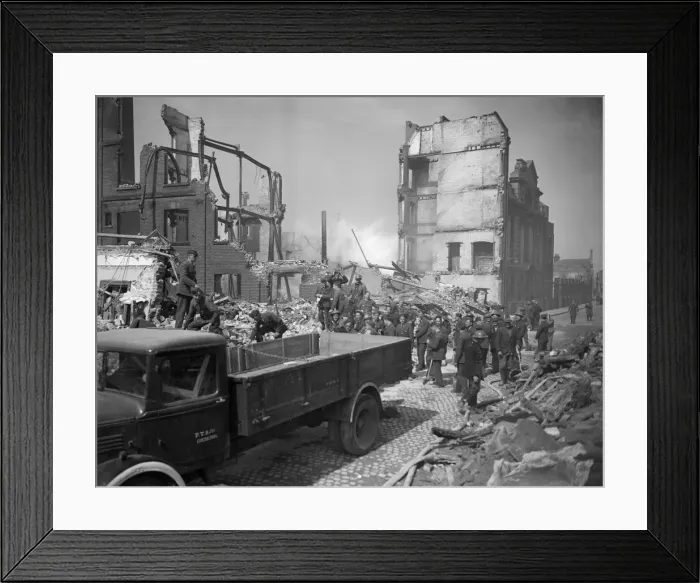 Framed Print : Bomb damage at Norwich Rescue workers at a bombed site after the an air raid search