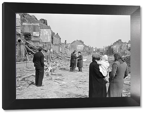 Shocked Londeners survey the destruction on their street, 19th March 1941