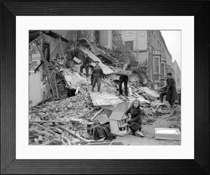 Framed Print : Bomb Damage at Bristol. A young girl who has salvaged her dolls house Framed Print : Bomb Damage at Bristol. A young girl who has salvaged her dolls house