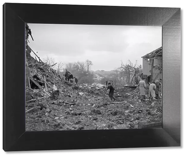 Air Raid Damage in Bristol Civilians searching through rubble of their bomb damaged