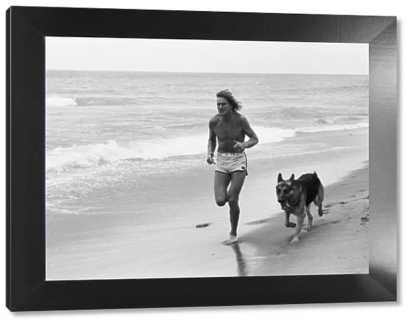 James Hunt jogging on beach with his dog Oscar in Marbella 9th May 1979