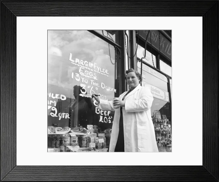 Framed Print : Norma Watson, manageress of a grocery shop in Sale, near Manchester repaints the egg sign Framed Print : Norma Watson, manageress of a grocery shop in Sale, near Manchester repaints the egg sign