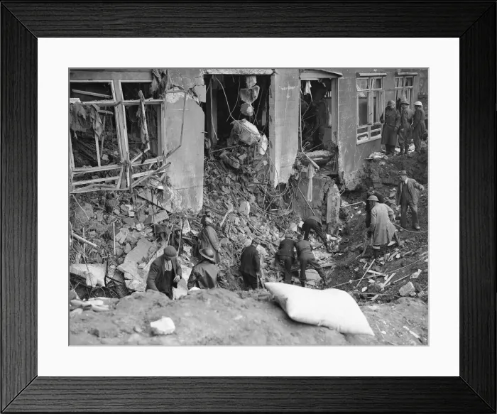 Framed Print : Workman and rescue workers search through the rubble and shell of the Coventry