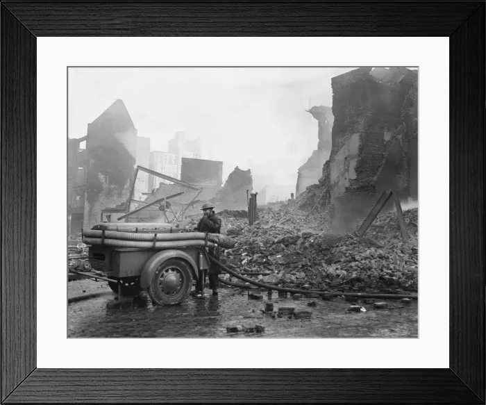 Framed Print : A rescue worker operating a Coventry Climax fire pump admist the shroud of smoke