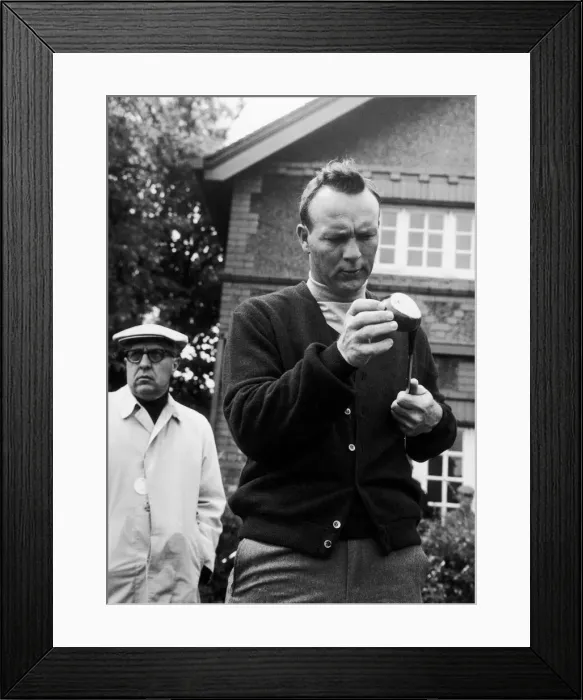 Framed Print : Arnold Palmer inspects one of his clubs. c. 1968 Framed Print : Arnold Palmer inspects one of his clubs. c. 1968