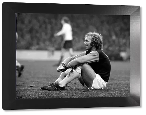 West Ham vs. Liverpool: Bobby Moore takes a rest during an injury to a Liverpool player