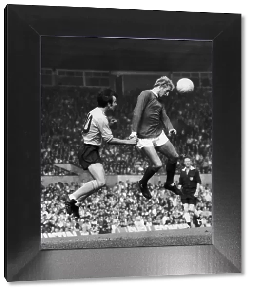 Denis Law of Manchester United beats Southamptons Tony Byrne during this heading
