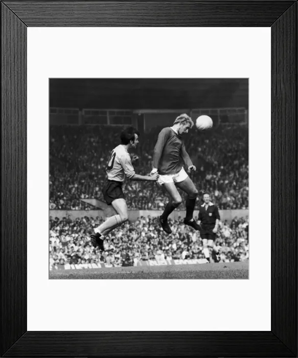 Framed Print : Denis Law of Manchester United beats Southamptons Tony Byrne during this heading Framed Print : Denis Law of Manchester United beats Southamptons Tony Byrne during this heading
