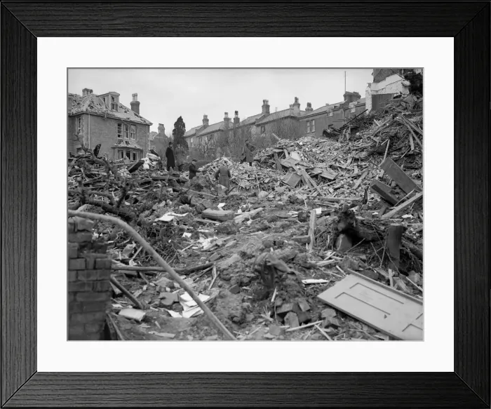 Framed Print : Air raid damage in Coventry Civilians search the rubble of thier bomb damaged