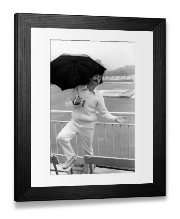 Framed Print : Graham Gooch England cricketer takes shelter from the rain under an umbrella as Framed Print : Graham Gooch England cricketer takes shelter from the rain under an umbrella as