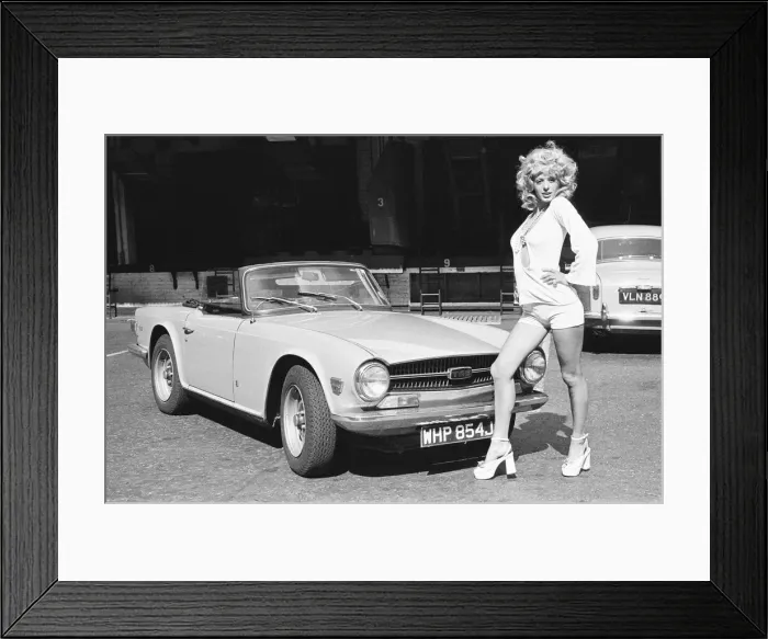 Framed Print : Reveille model Nicky Howarth seen here posing with a TR6 car which is top prize in Framed Print : Reveille model Nicky Howarth seen here posing with a TR6 car which is top prize in