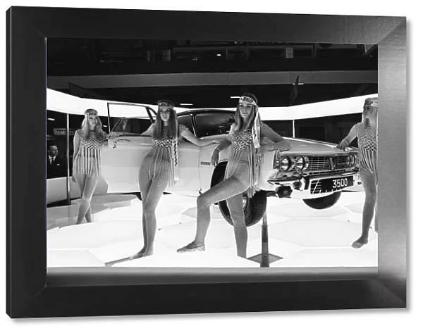 Models drapped over A Rover motor car on the Dunlop Tyre stand at the 1969 Motor Show