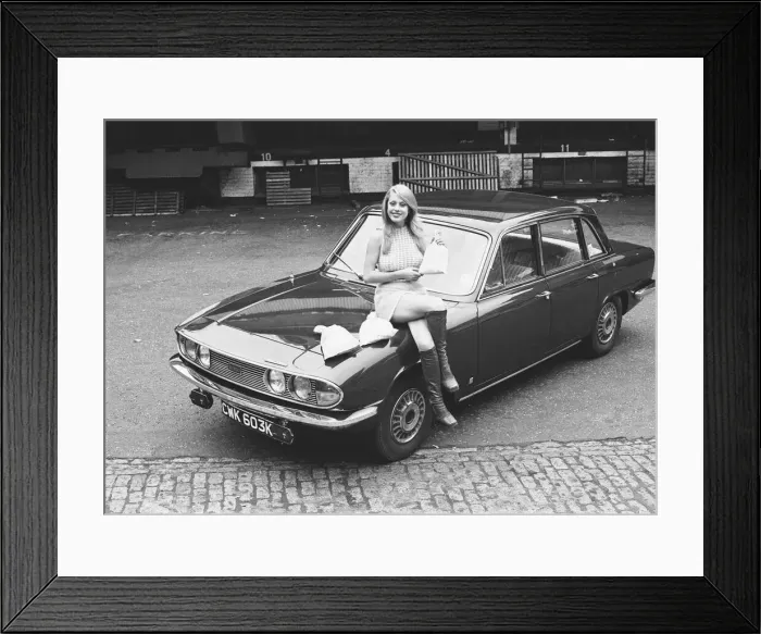 Framed Print : Reveille model seen here posing with a Triumph 2000 which is top prize in the Reveille Framed Print : Reveille model seen here posing with a Triumph 2000 which is top prize in the Reveille