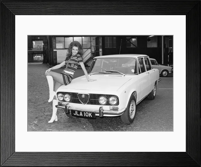Framed Print : Reveille model seen here posing with a Alfa Romero car which is top prize in the Reveille Framed Print : Reveille model seen here posing with a Alfa Romero car which is top prize in the Reveille