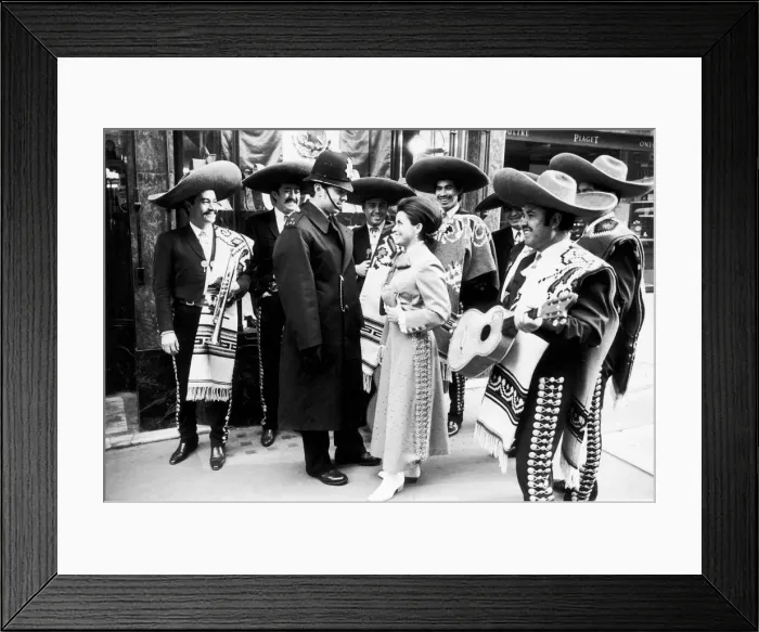 Framed Print : Mexican singer Maria de Lourdes tries her charms on a London policeman to no avail