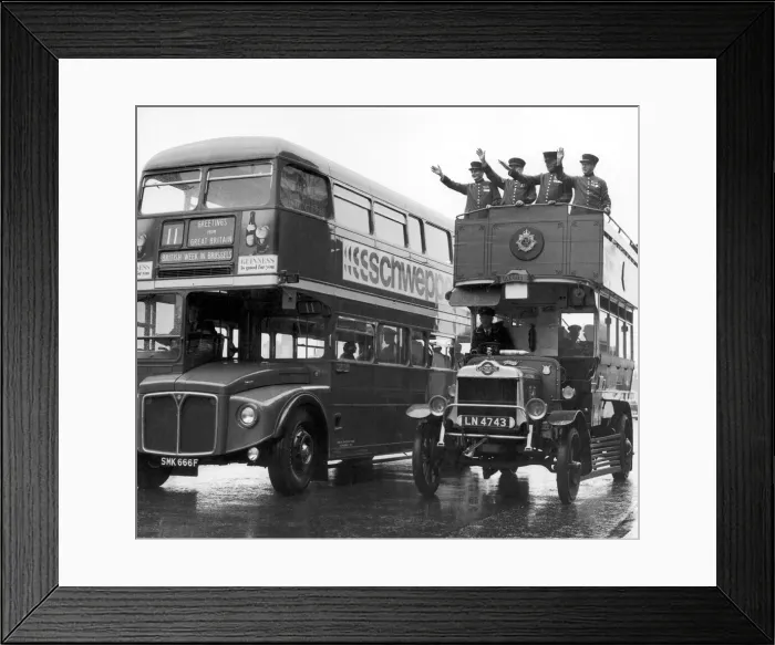 Framed Print : Ole Bill, a London bus form around 1914, is overtaken by one of the modern day Framed Print : Ole Bill, a London bus form around 1914, is overtaken by one of the modern day