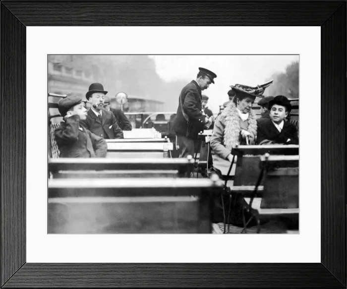 Framed Print : A conductor checks for passengers tickets on the open top deck of a London tram Framed Print : A conductor checks for passengers tickets on the open top deck of a London tram