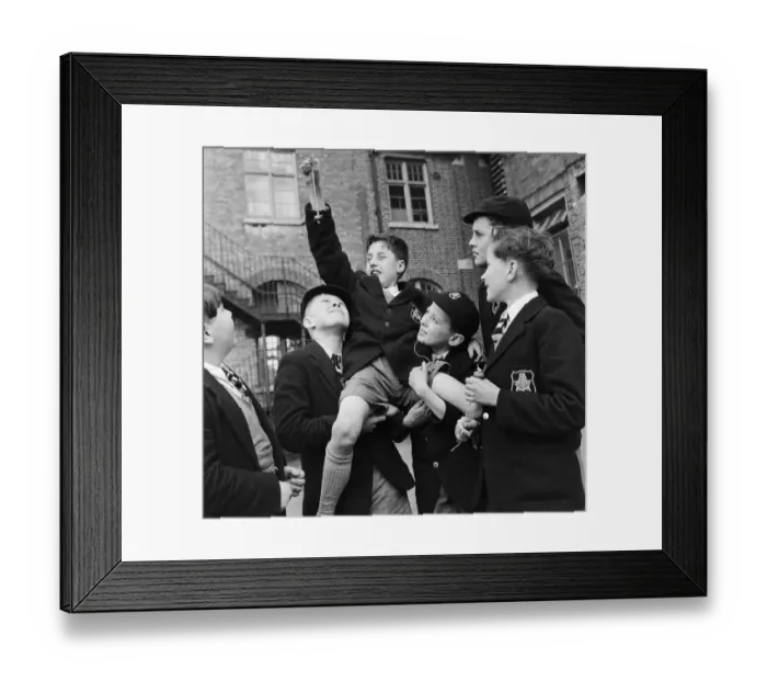 Framed Print : A group of friends taking part in a game of conkers at their school. September 1950