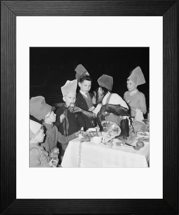 Framed Print : Chimpanzees of Bertram Mills circus with children at a Christmas party Framed Print : Chimpanzees of Bertram Mills circus with children at a Christmas party