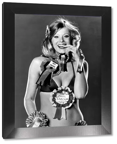 Model Jan Burdette wearing a collection of rosettes on the day of the General Election