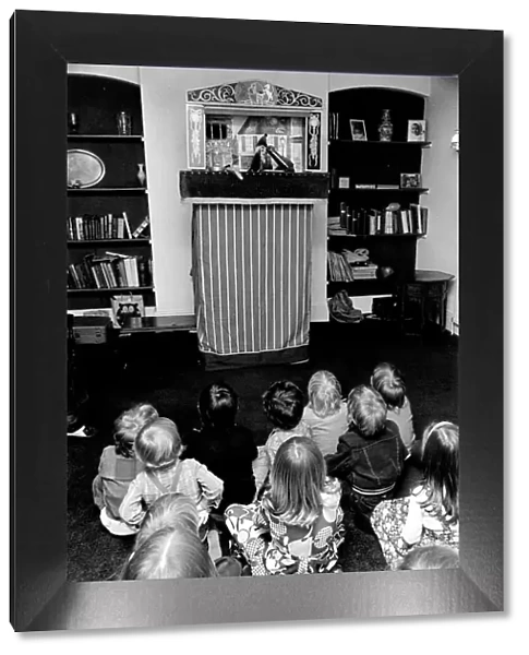 Children sitting on the floor watching the Pinch and Judy puppet show at a party