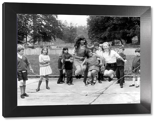 Schoolchildren skipping in the playground. 10th October 1971