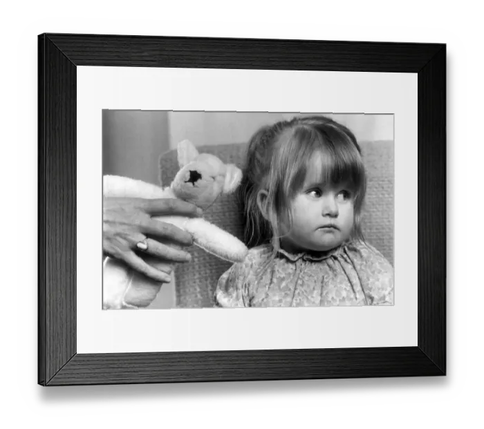 Framed Print : Two year old Samantha Cousins who is blind is offered a replacement teddy bear for Framed Print : Two year old Samantha Cousins who is blind is offered a replacement teddy bear for