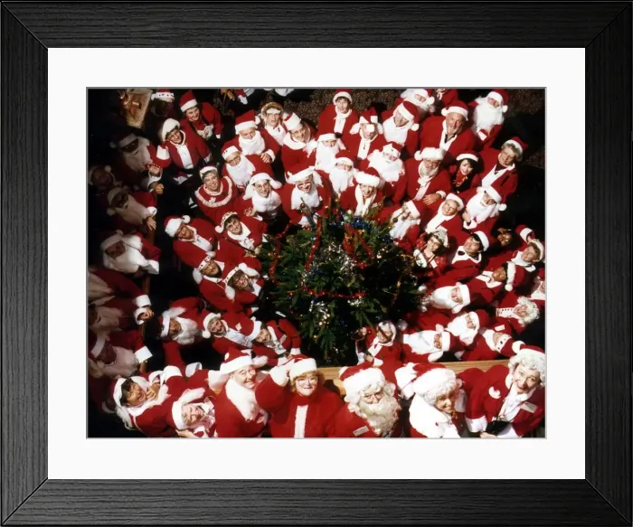 Framed Print : A group of Santas pose at a Christmas party. 19th December 1991