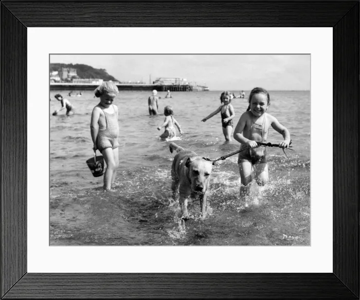 Framed Print : Holiday scene at Torquay. Susan Reeve with her dog. 31st May 1958 Framed Print : Holiday scene at Torquay. Susan Reeve with her dog. 31st May 1958
